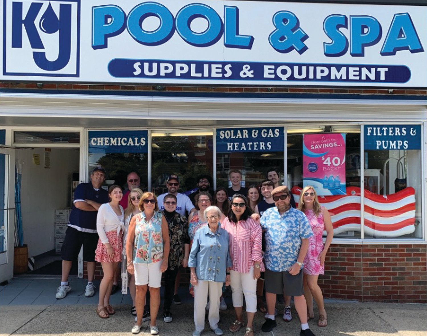 IN THE FAMILY: Maureen Hennessey Hager and her brother-in-law, John Medeiros, have run KJ Pool & Spa on Pontiac Avenue for decades. Here, they are pictured during a gathering of family members at the store over the summer.
